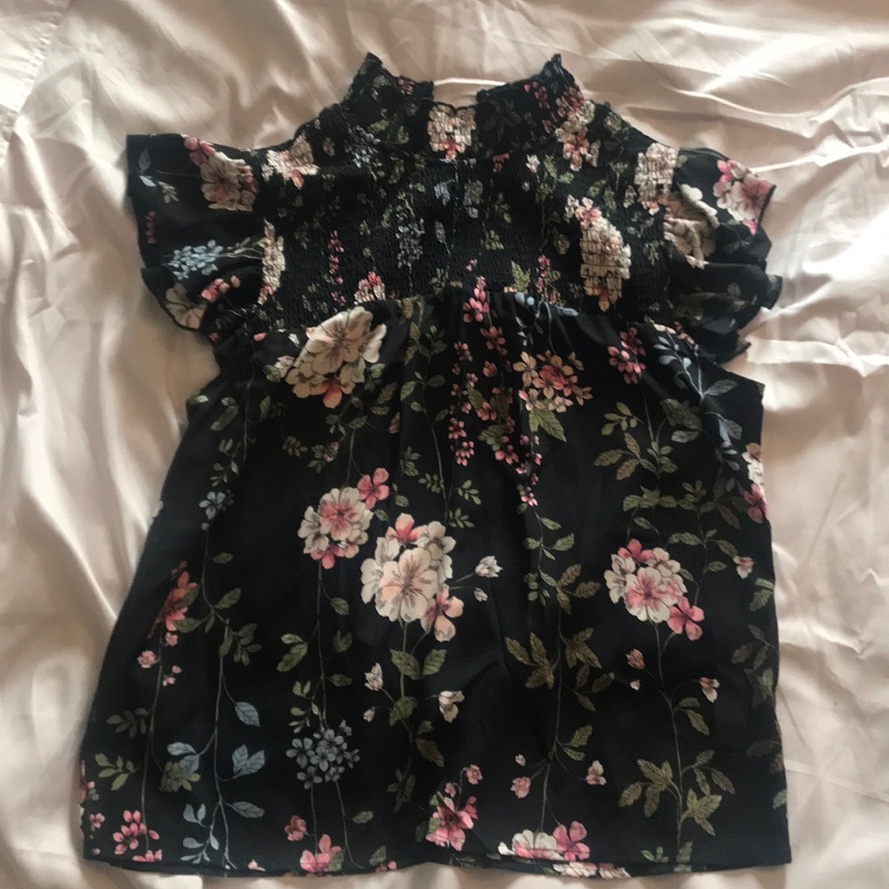 Women’s black blouse with flowers.